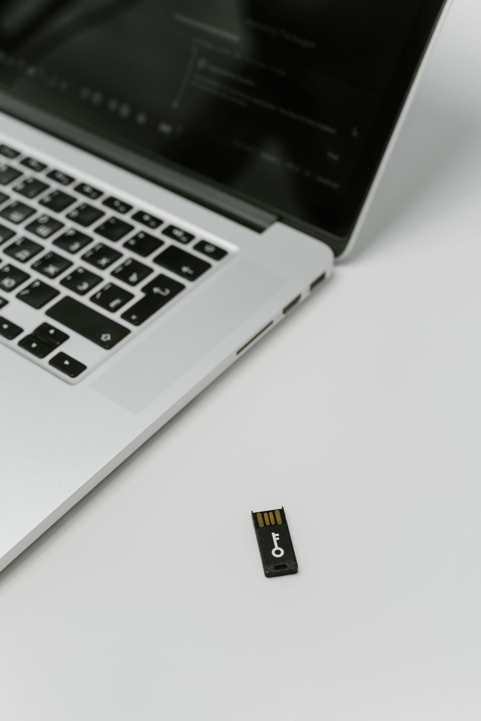 USB hardware security key next to a laptop